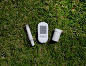 a thermometer, a thermometer, and a pill on the grass
