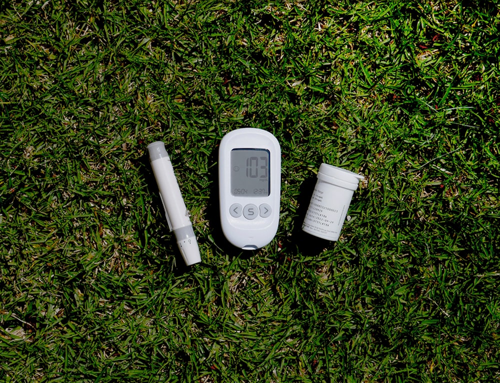 a thermometer, a thermometer, and a pill on the grass