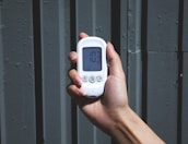 Close-up of a hand holding a phone displaying the Clairvoyance Pro contact number.