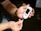 A person is holding a white glucose meter in their hands, preparing to take a blood sugar test. The focus is on the meter and the person's hands, with sunlight casting shadows across the scene.
