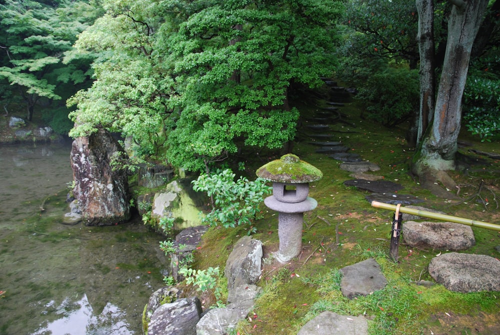 a stone lantern in the middle of a forest