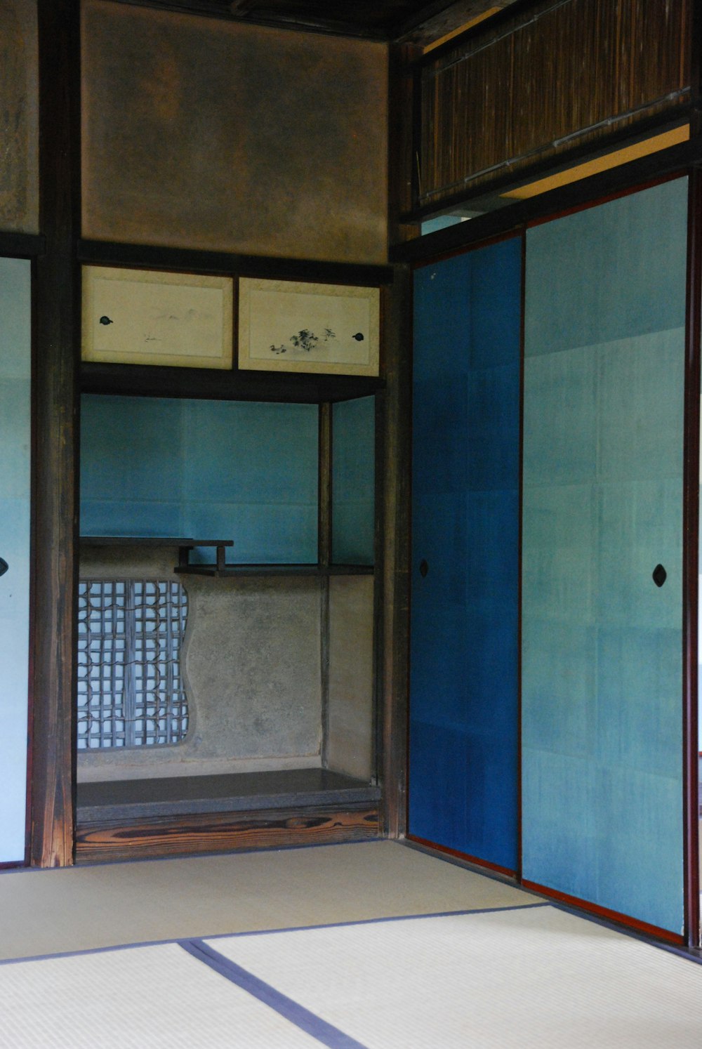 a room with blue doors and a white floor