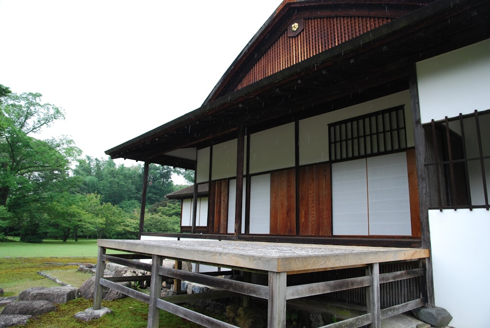 a wooden bench sitting in front of a building