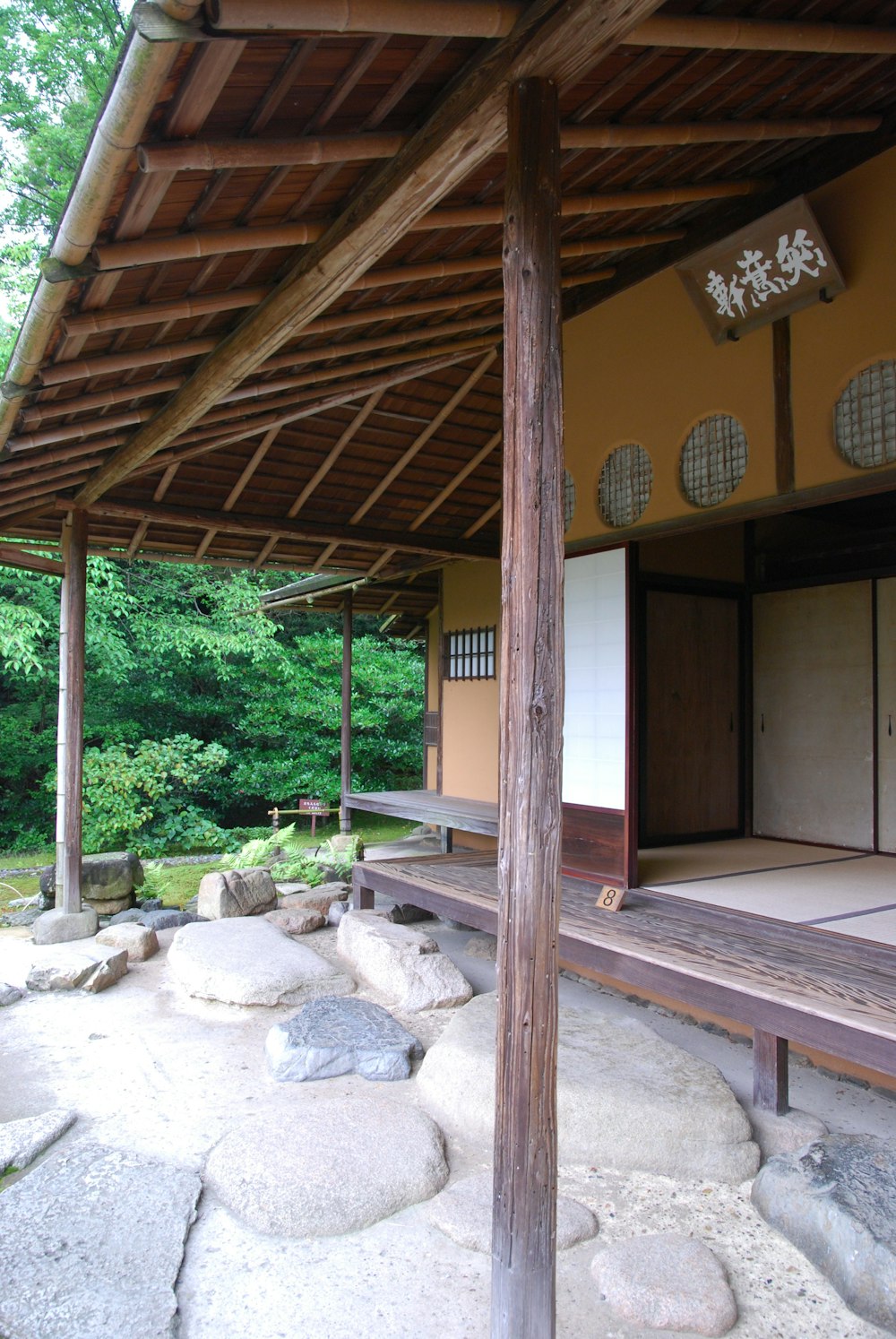 a building with a wooden roof and a stone walkway