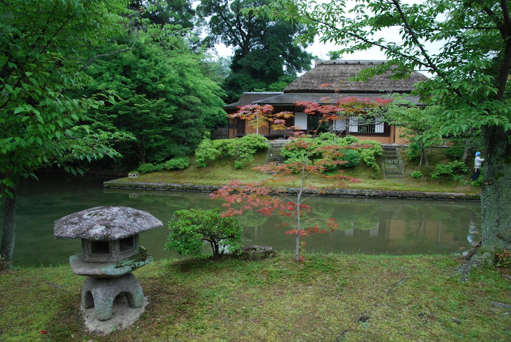 a small house sitting next to a body of water