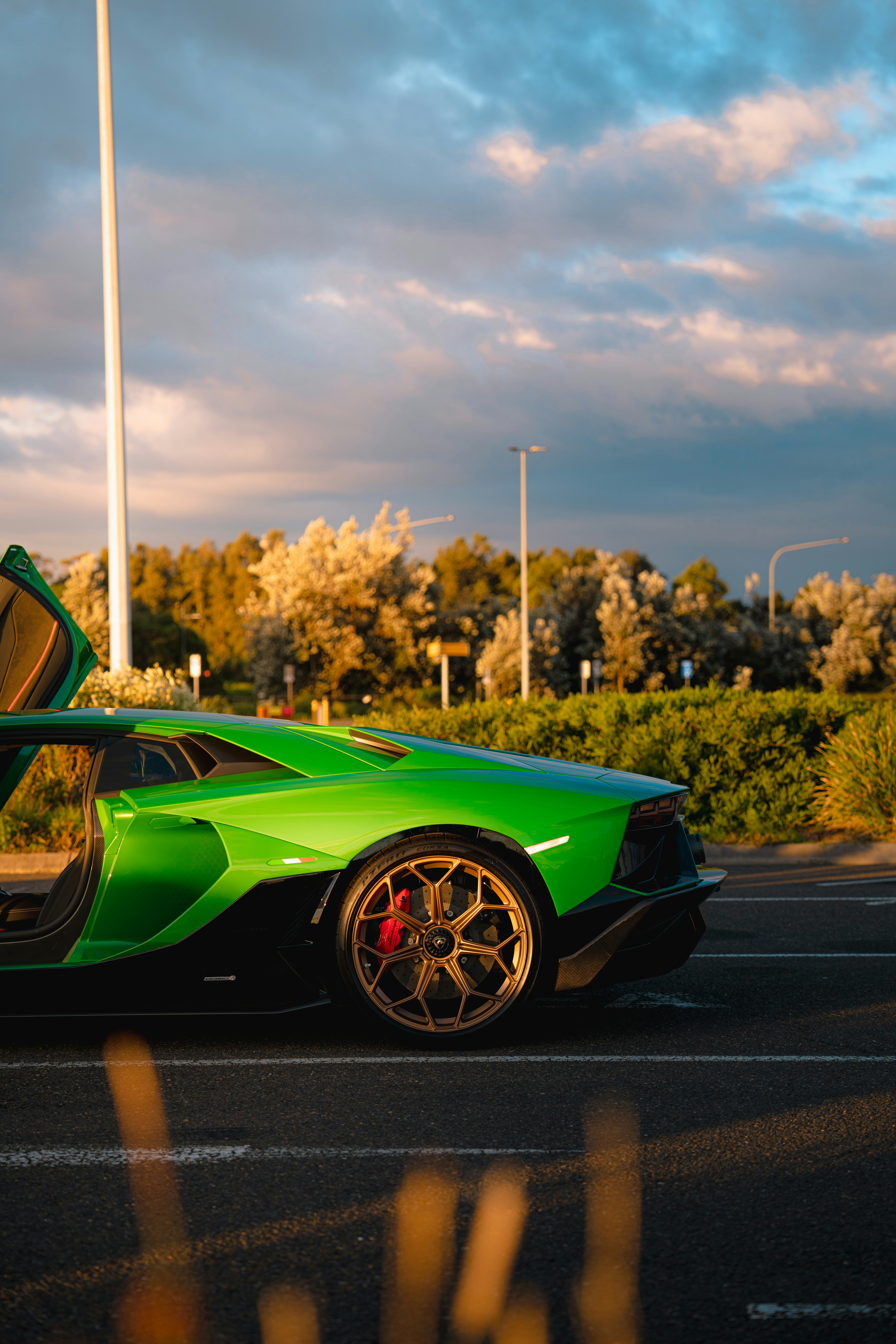 a green sports car parked in a parking lot