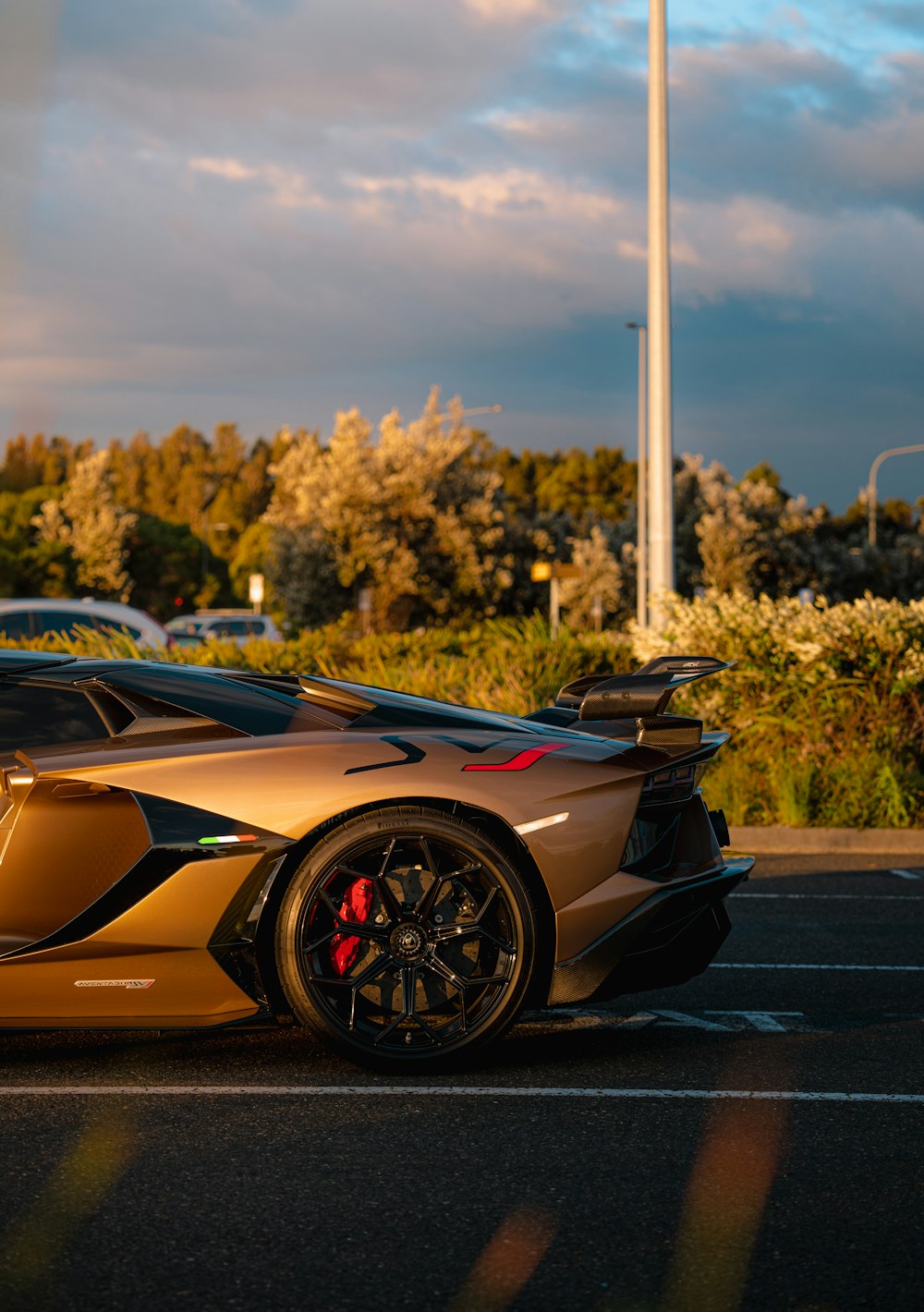 a gold sports car parked in a parking lot