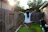 A joyful Brazilian boy catching a flying spinner ball in a backyard at sunset.