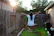 A joyful Brazilian boy catching a flying spinner ball in a backyard at sunset.