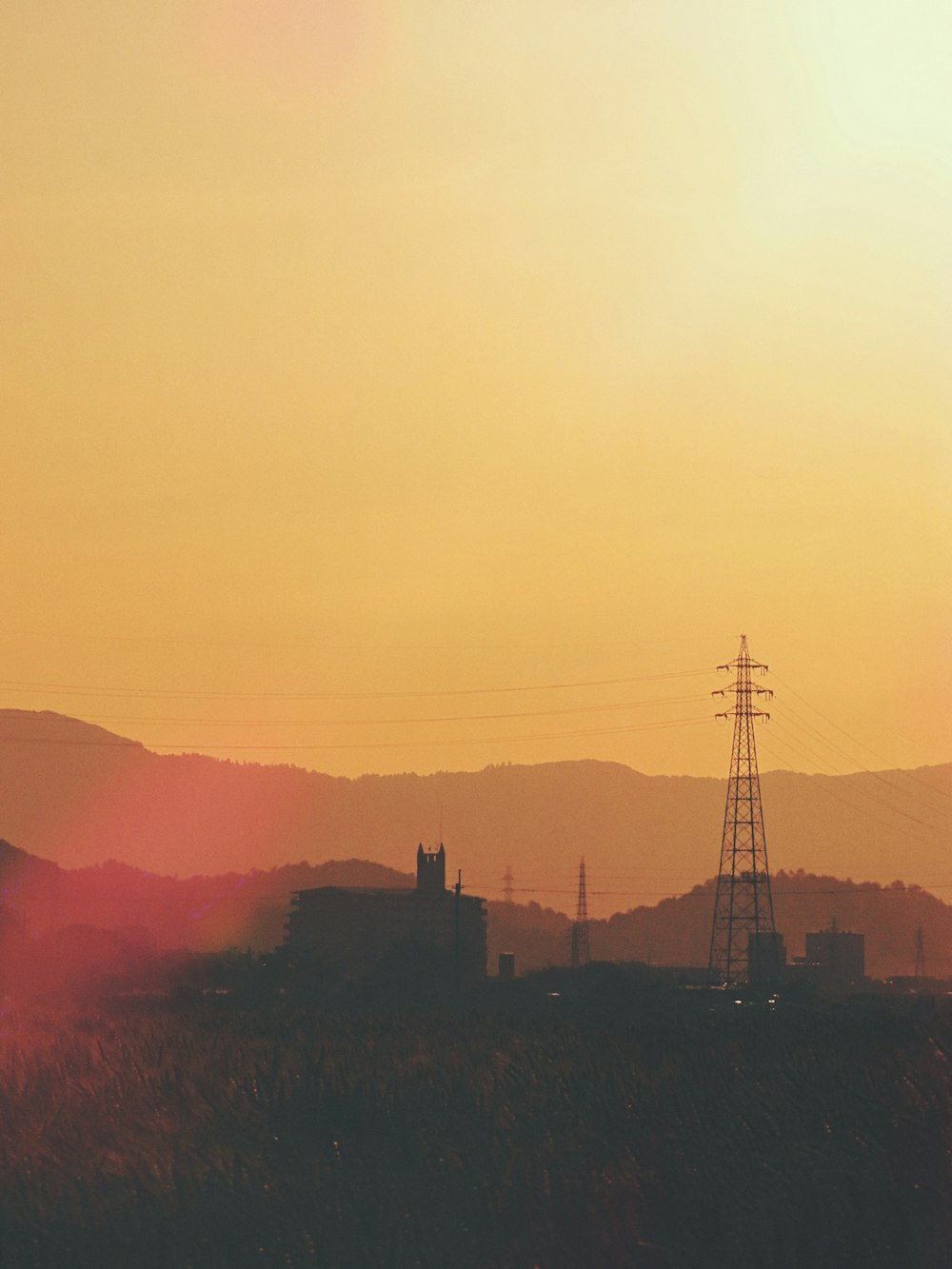 the sun is setting over a mountain range