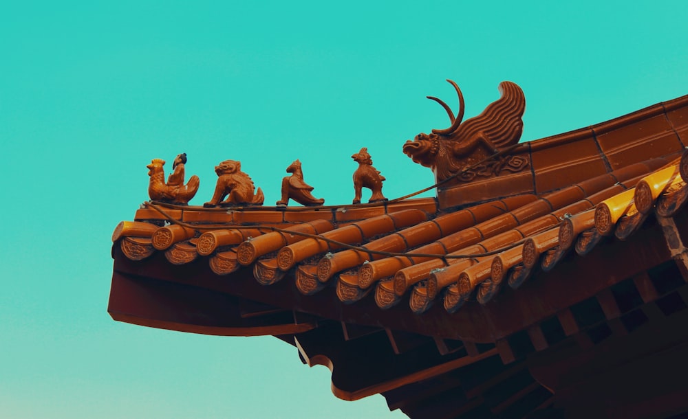 the roof of a building with a group of figurines on it