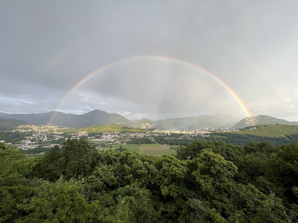 a double rainbow over a lush green valley