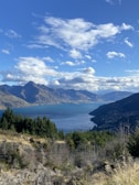 A stunning landscape featuring a serene lake surrounded by mountains.