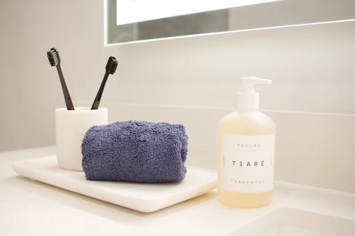 Organized small bathroom counter with toothbrushes, towel, and soap