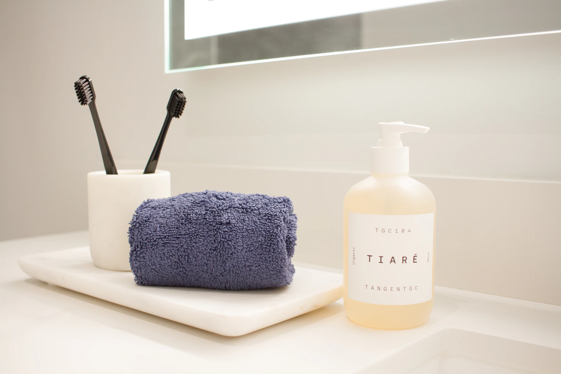 Soap, toothbrush and personal care items arranged on a clean bathroom counter for a daily hygiene routine