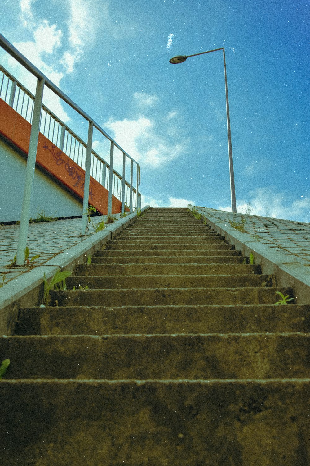 a set of stairs leading up to a street light