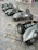 A group of vintage Lambretta scooters lined up on a sunny Canadian roadside, riders chatting nearby.