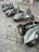 A group of vintage Lambretta scooters lined up on a sunny Canadian roadside, riders chatting nearby.
