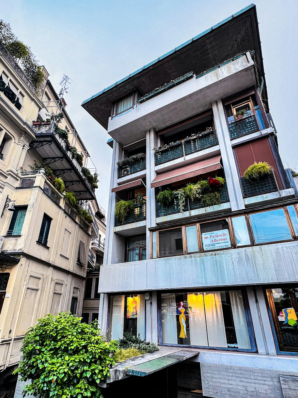 a tall building with lots of windows next to other buildings