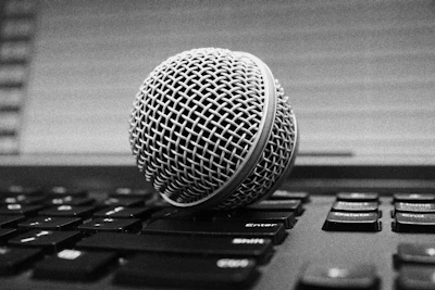 Close-up of a microphone with digital sound waves illustrating AI voice technology.