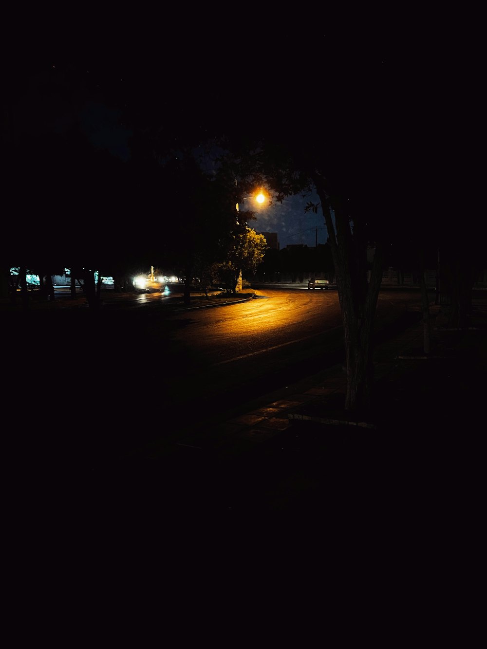 a dark street at night with street lights