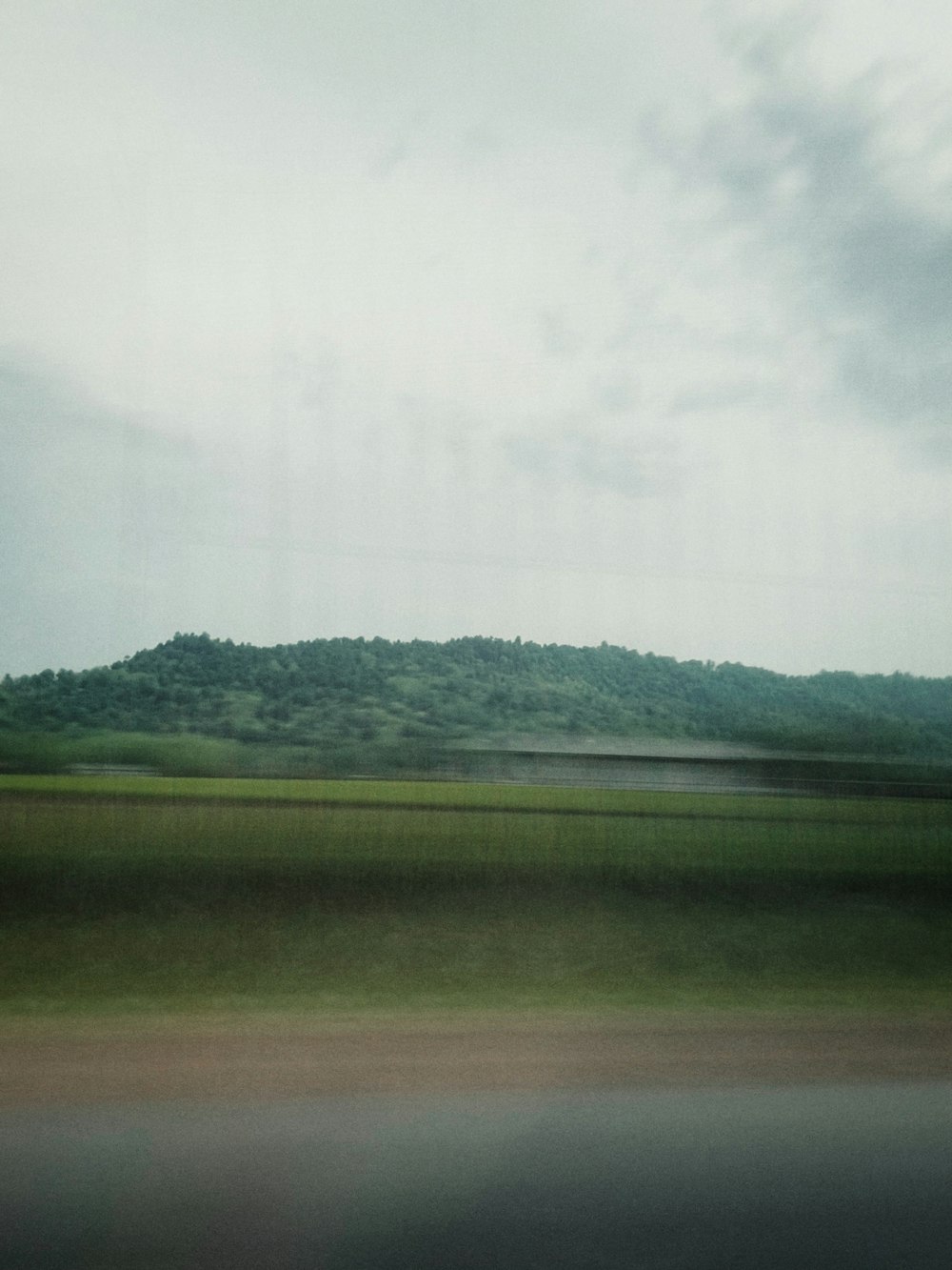 a view of a hill from a moving vehicle