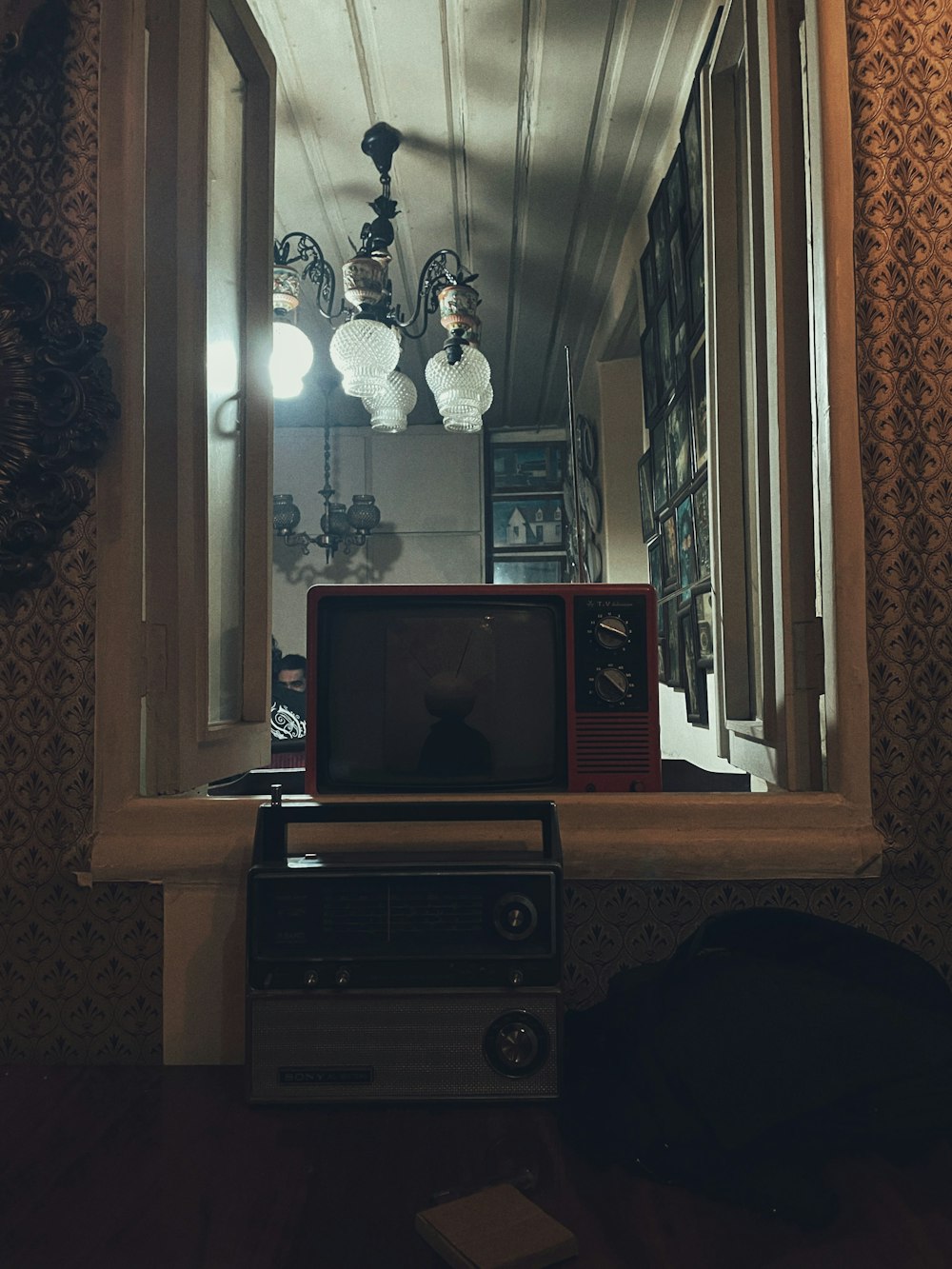 a television sitting on top of a table next to a window