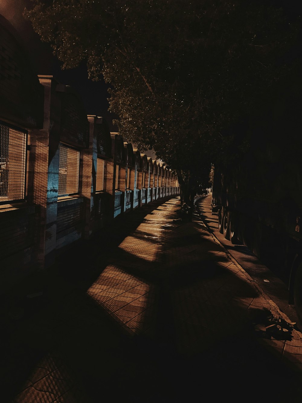a dark street at night with a row of buildings