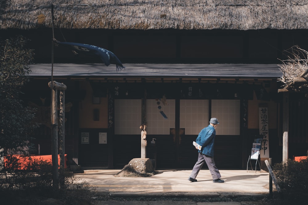 a man walking in front of a building