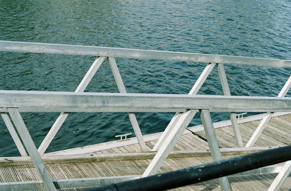 a wooden dock next to a body of water