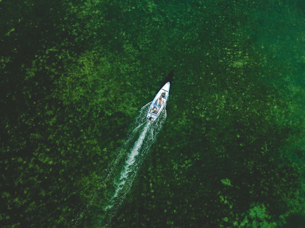 an aerial view of a boat in a body of water