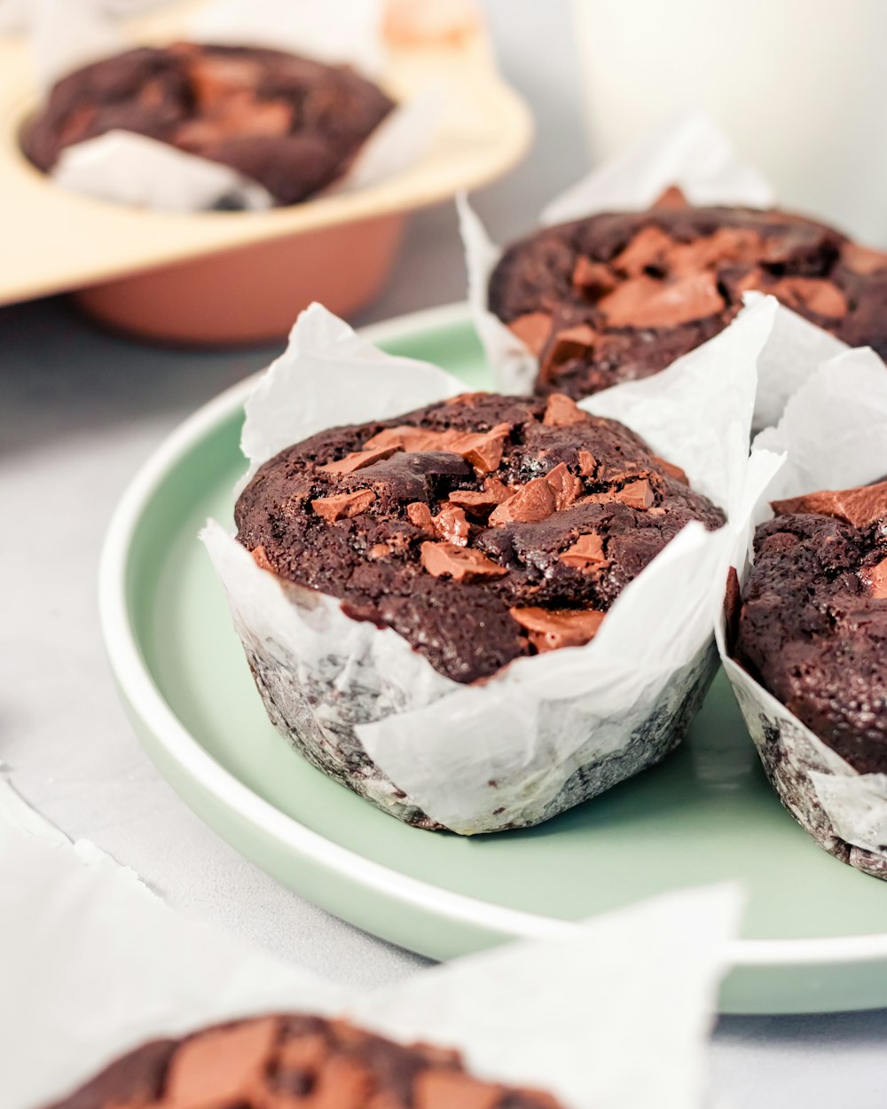 a plate of chocolate muffins on a table