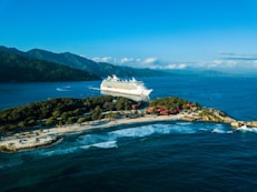 a cruise ship is docked at a small island