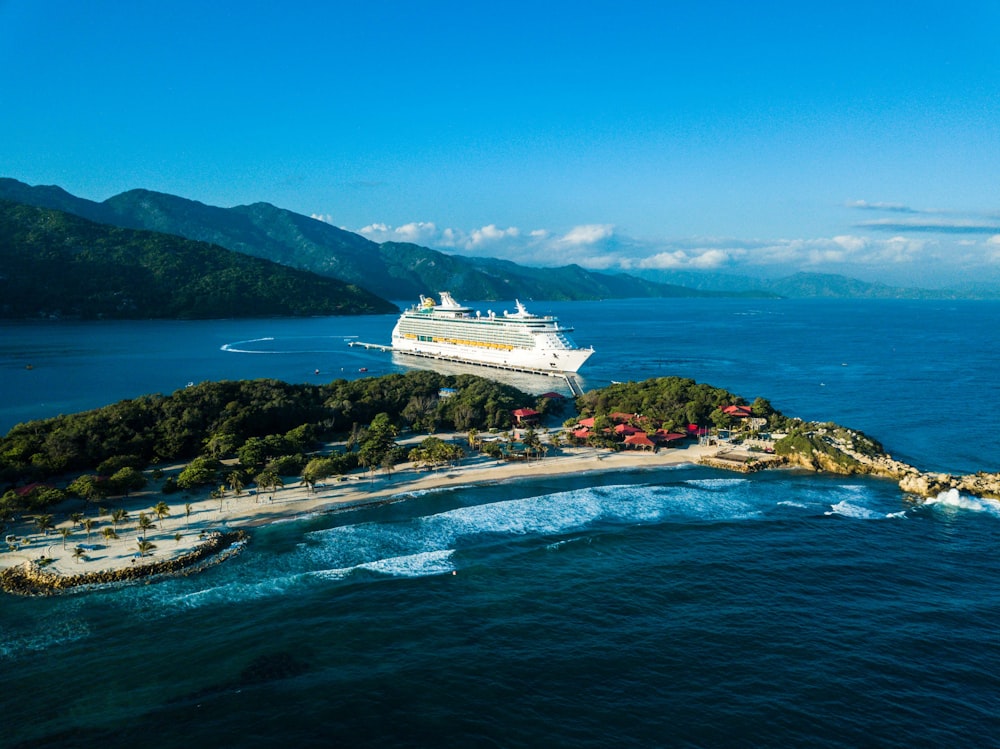 a cruise ship is docked at a small island