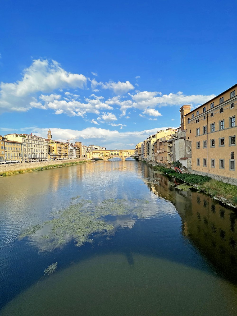 a river running through a city next to tall buildings