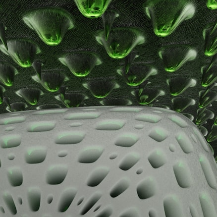 A textured surface with patterns resembling futuristic architecture. The upper portion displays a series of green, cone-shaped elements while the lower area features a soft gray surface with abstract oval cutouts.