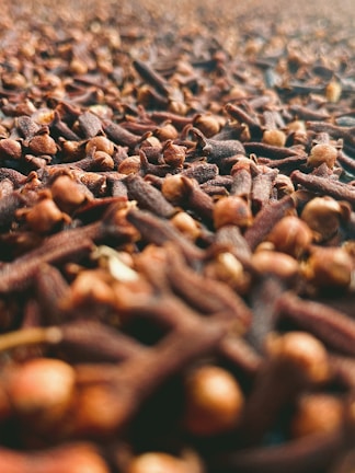 A close-up of fresh, aromatic cloves on a wooden surface.