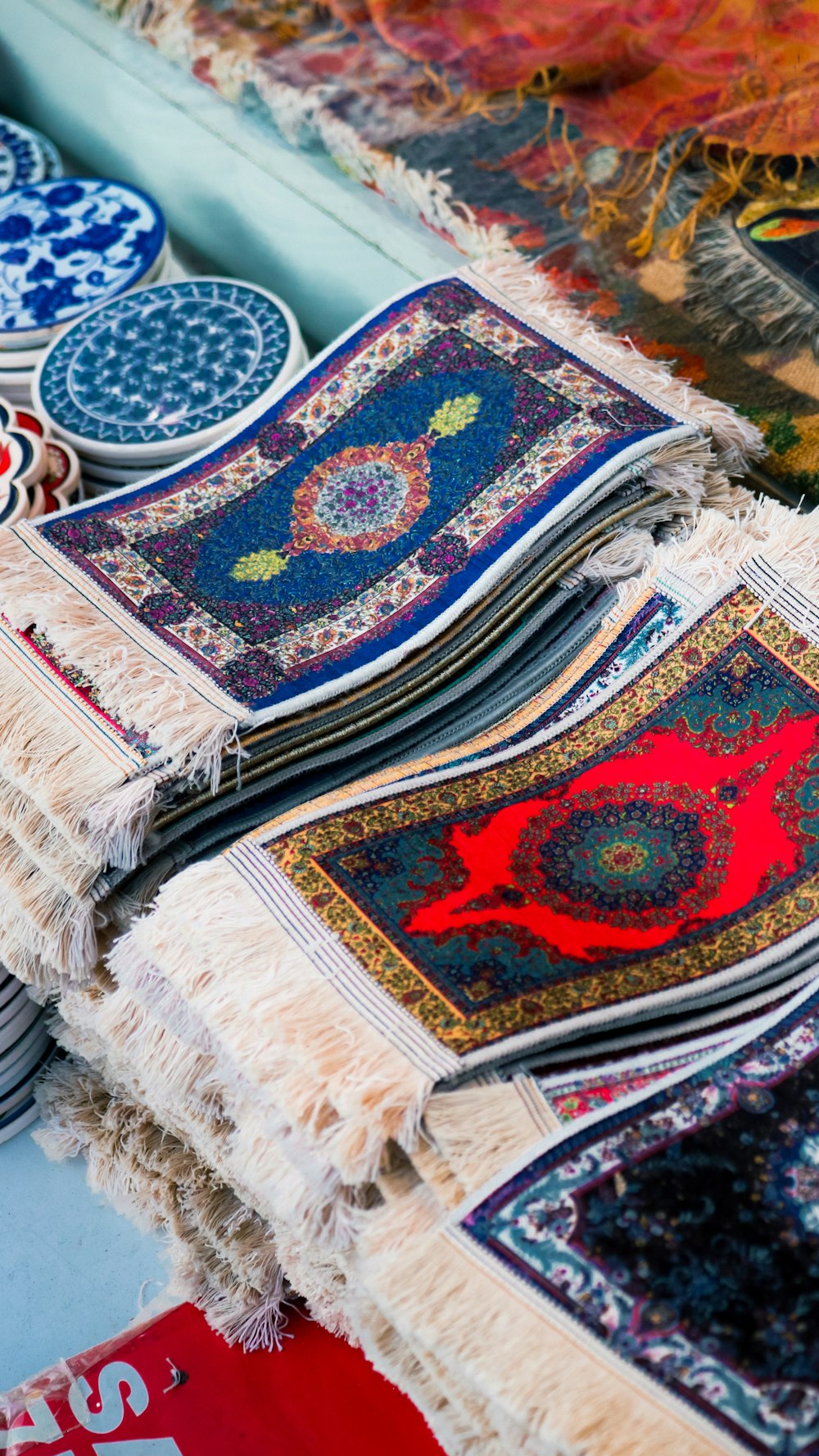 a table topped with lots of different types of rugs