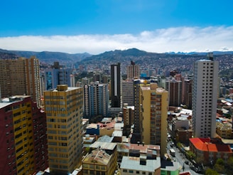 a city with tall buildings and mountains in the background