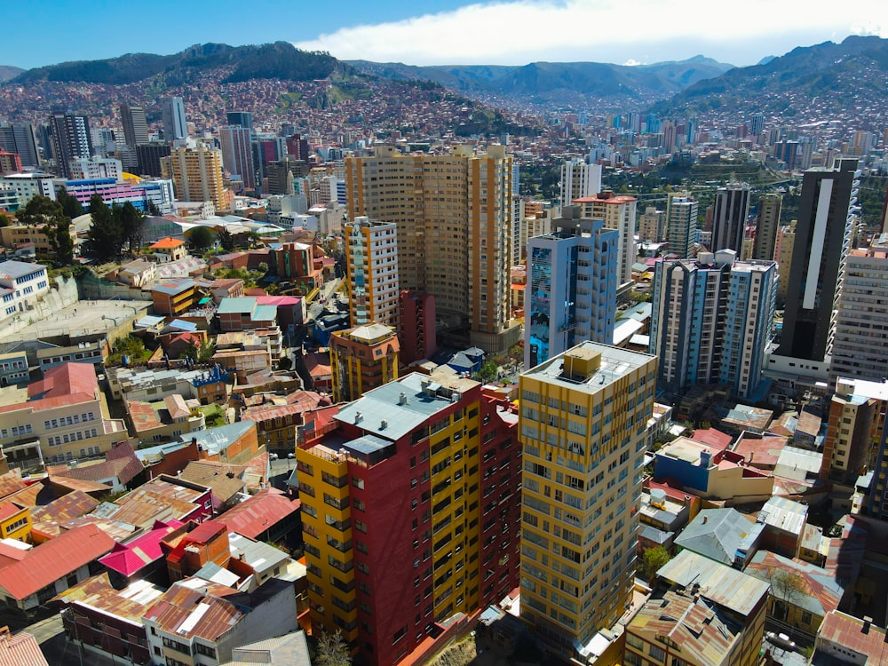 a city with tall buildings and mountains in the background