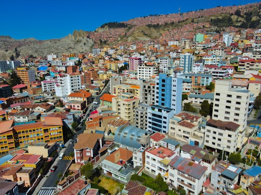 a city with lots of tall buildings next to a mountain