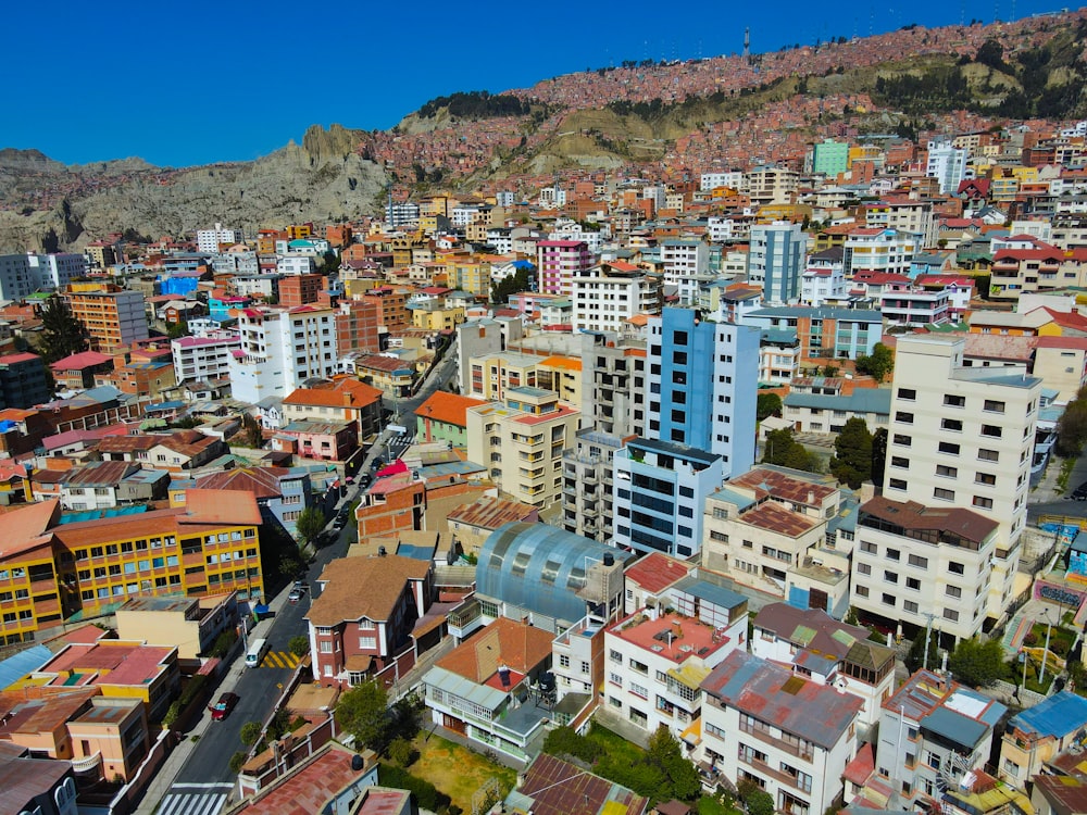 a city with lots of tall buildings next to a mountain