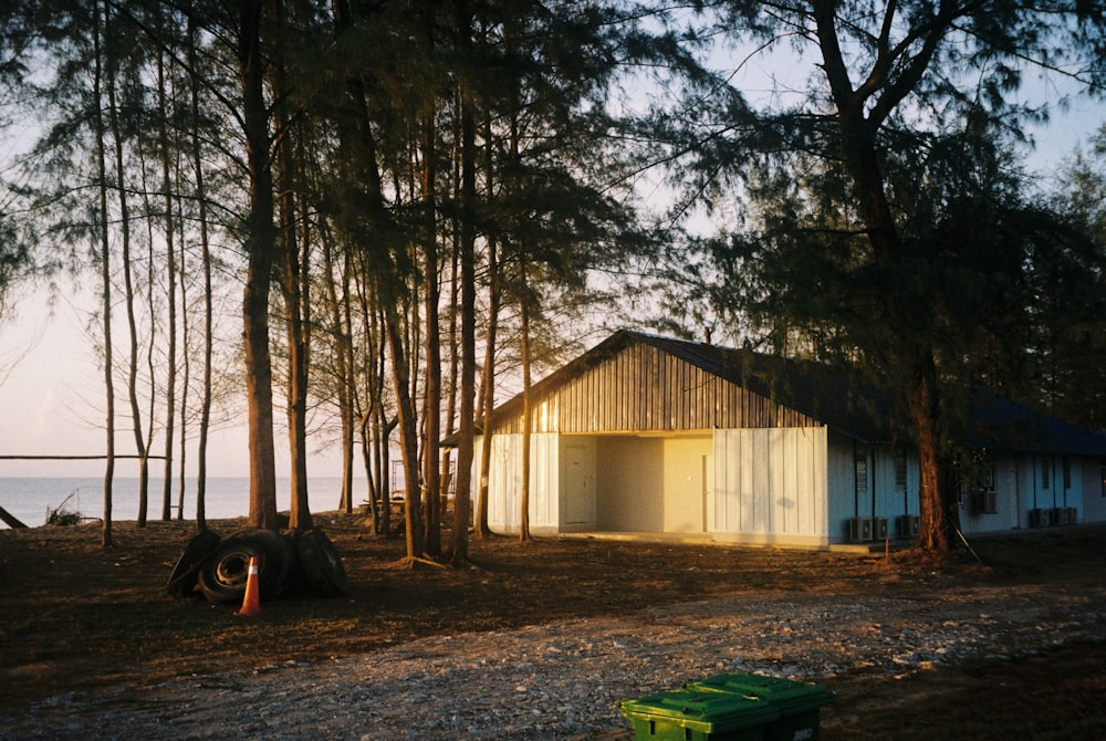 a house in the woods next to a body of water