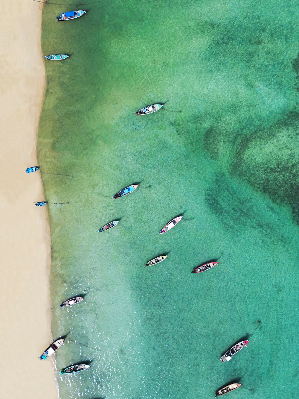 a group of boats floating on top of a body of water