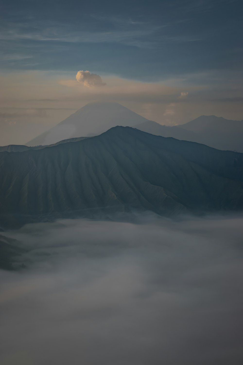 a view of a mountain covered in fog