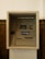 An ATM machine embedded in a wall, featuring a screen, card slot, keypad, and cash dispenser. The surrounding surface is tiled and the machine has a 'ATMANDIRI' logo displayed prominently.