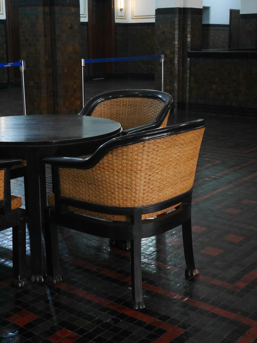 a table and chairs in a room with tiled floors