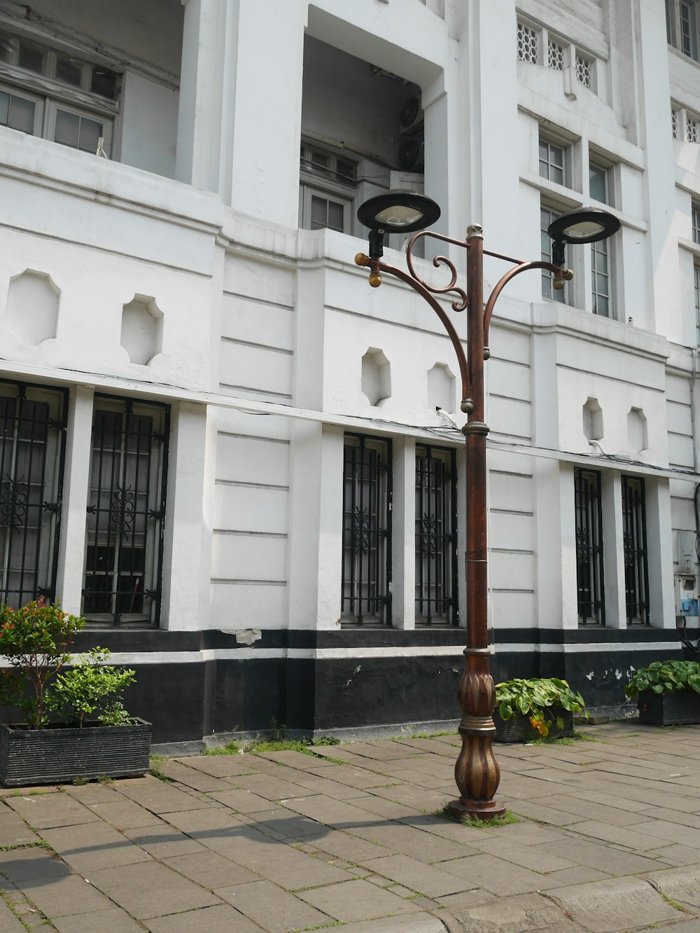 a street light in front of a white building
