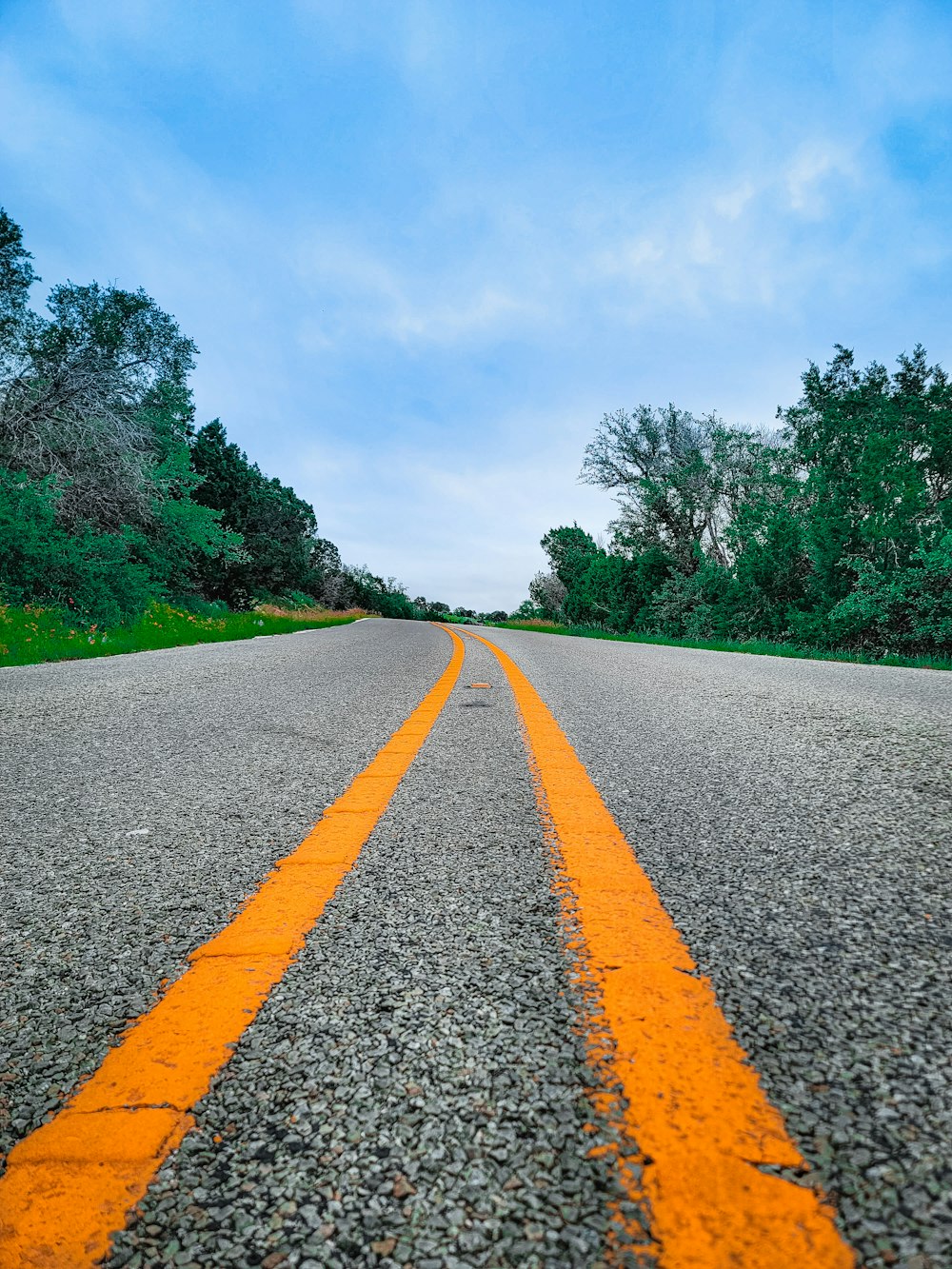 an empty road with a yellow line painted on it