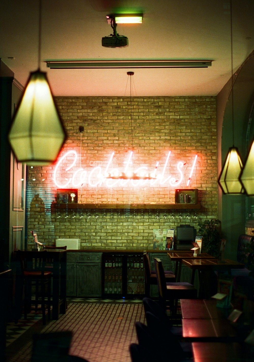 a brick wall with a neon sign on it